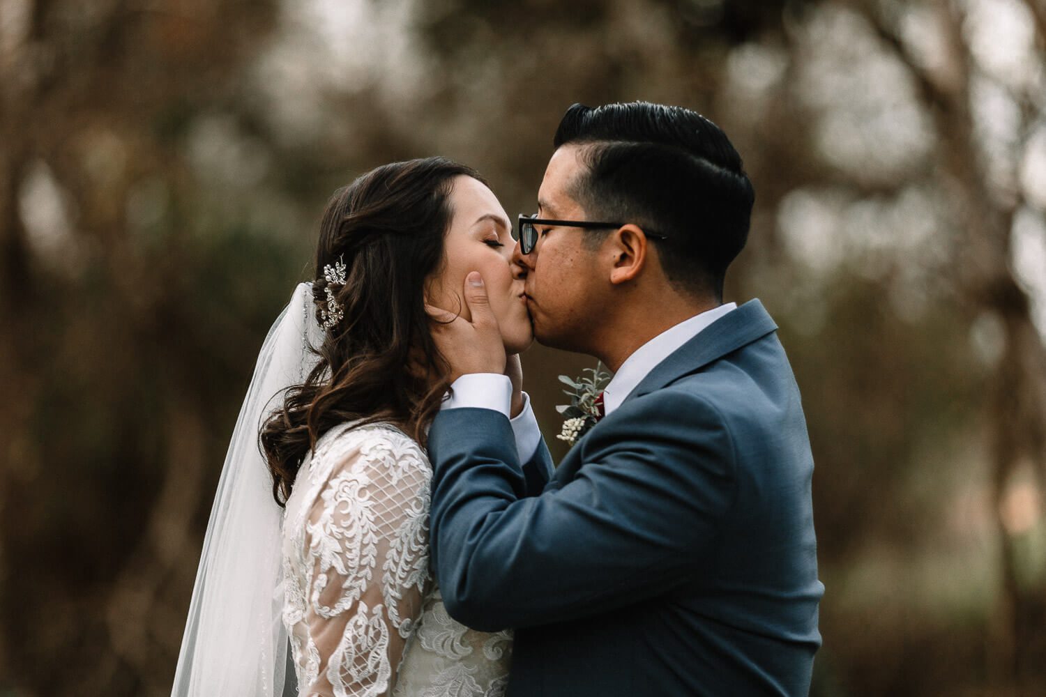 bride and groom kiss with passion after wedding ceremony at Texas Old Town - Sage Hall