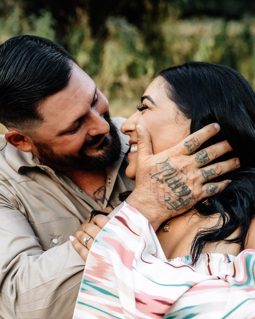 romantic couple gazes into each others eyes during engagement photo session at Dos Palomas Ranch wedding venue in Boerne, Texas