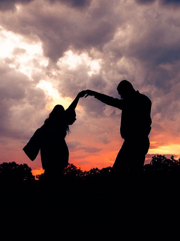 silhouette of groom dancing with bride during a Texas sunset at Dos Palomas Ranch in Boerne, TX