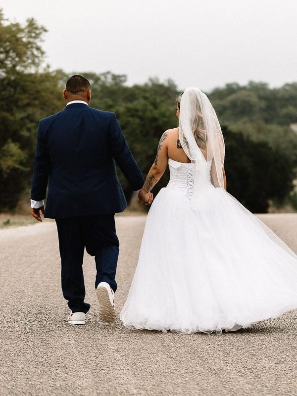 bride and groom walking down street holding hands after intimate ceremony